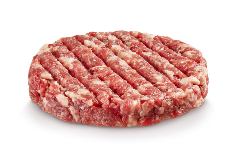 Raw hamburger patty isolated on white Raw hamburger patty isolated on white